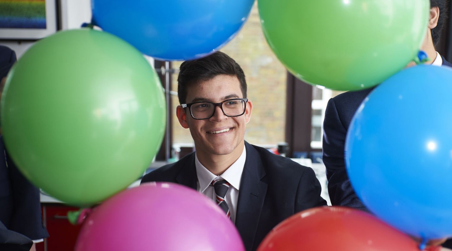 Student and balloons