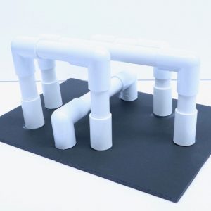 A set of plastic pipes coordinated on a black board